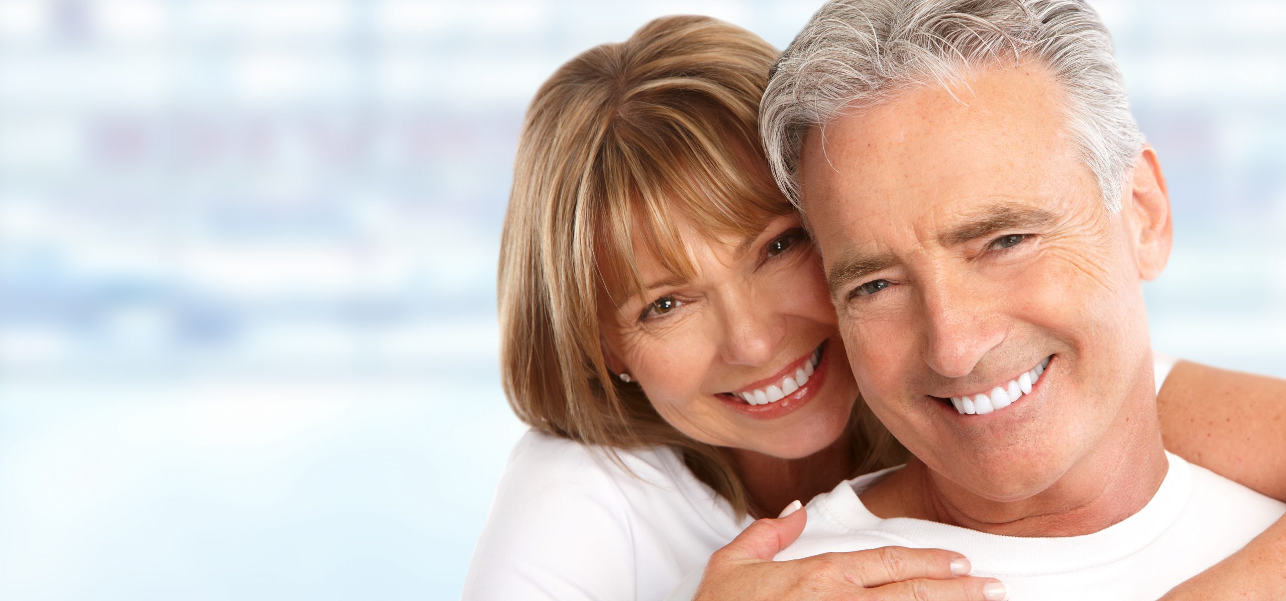 Elderly couple with white teeth.
